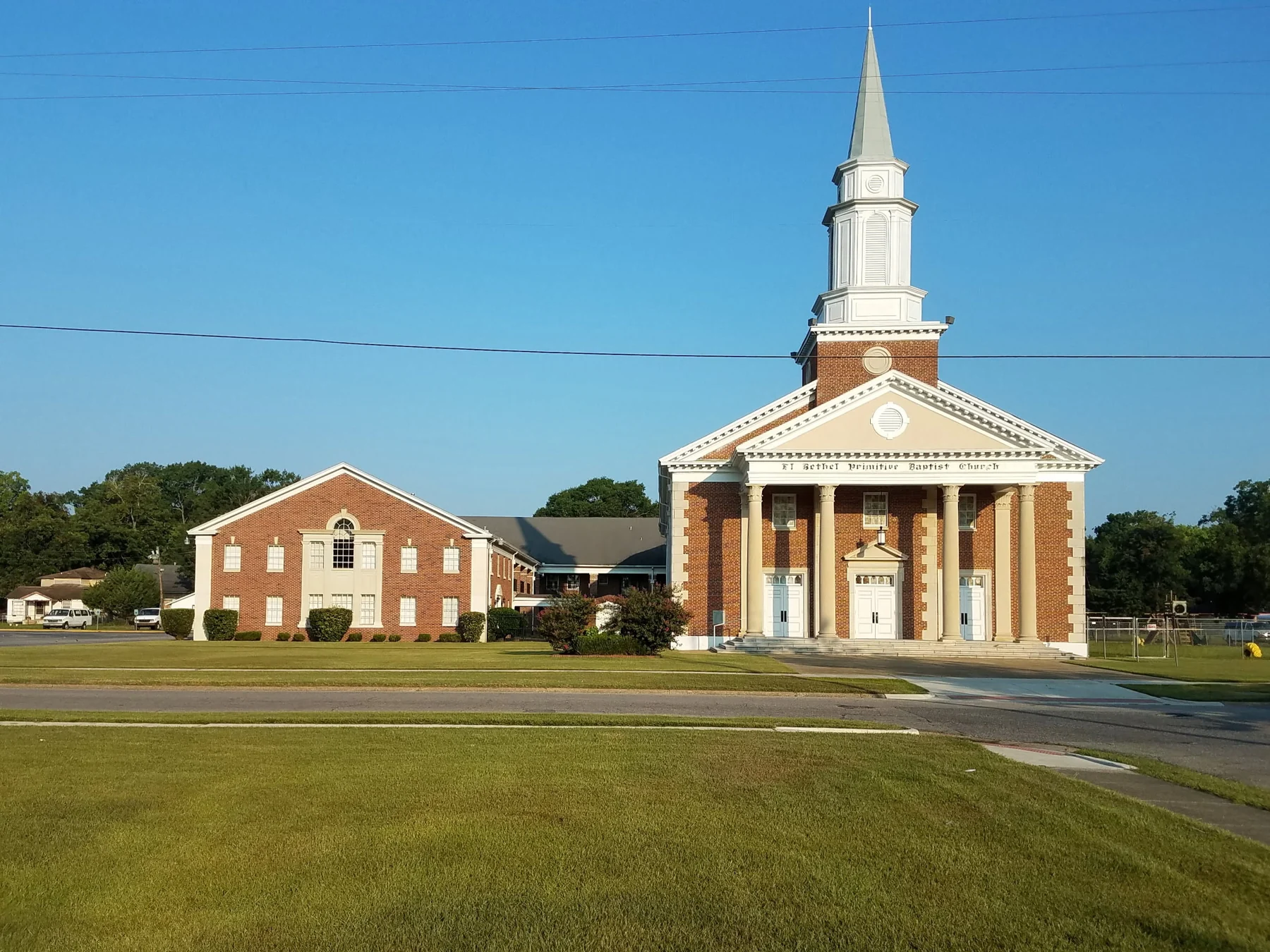 Exterior of El Bethel Primitive Baptist Church, showing its brick sanctuary, white columns and steeple in Mobile, Alabama