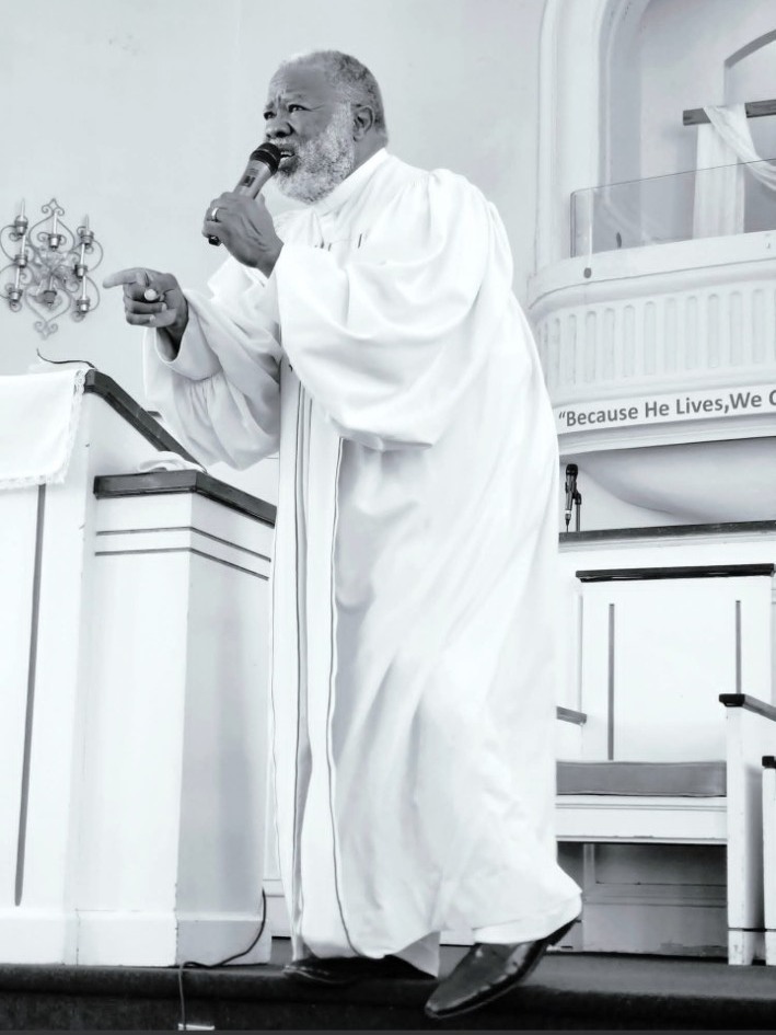 Reverend Dr. Jonathan L. Yates preaching from the pulpit in the El Bethel sanctuary